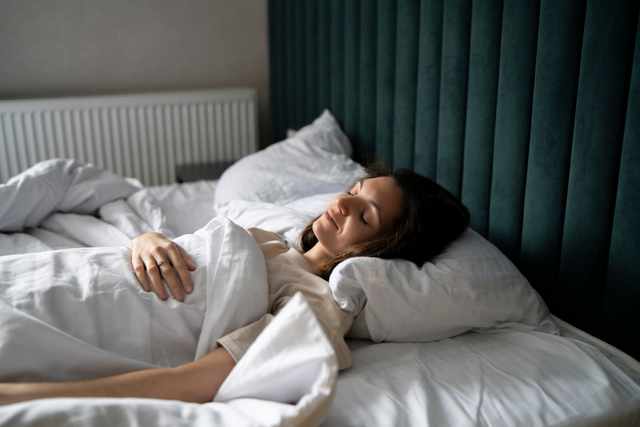 Peaceful Side Sleeper Woman sleeping peacefully on her side in a well-lit bedroom