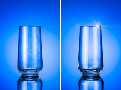 A clean and dirty glass side-by-side against a blue background 