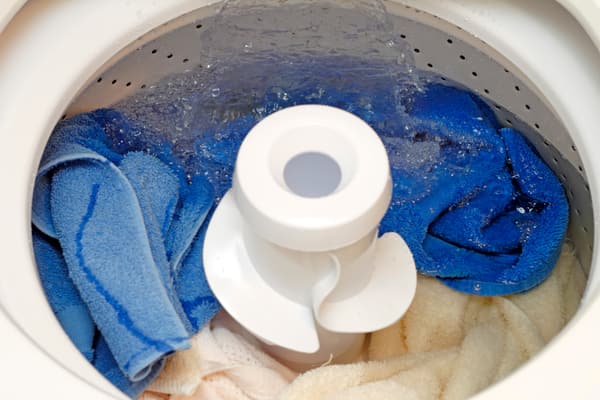 A top load washer filling with water 