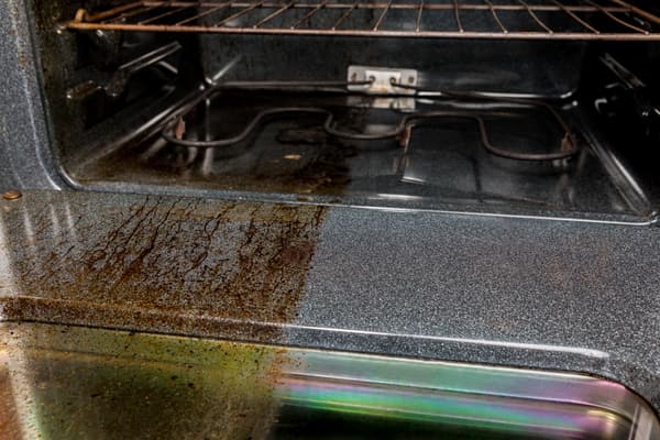 A side by side of a cleaned and uncleaned oven surface