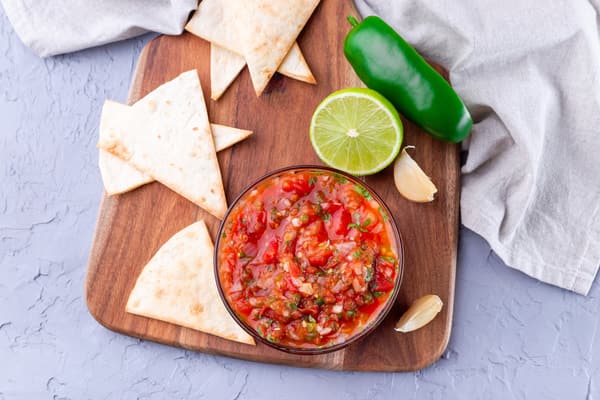 Overhead view of a bowl of salsa and chips