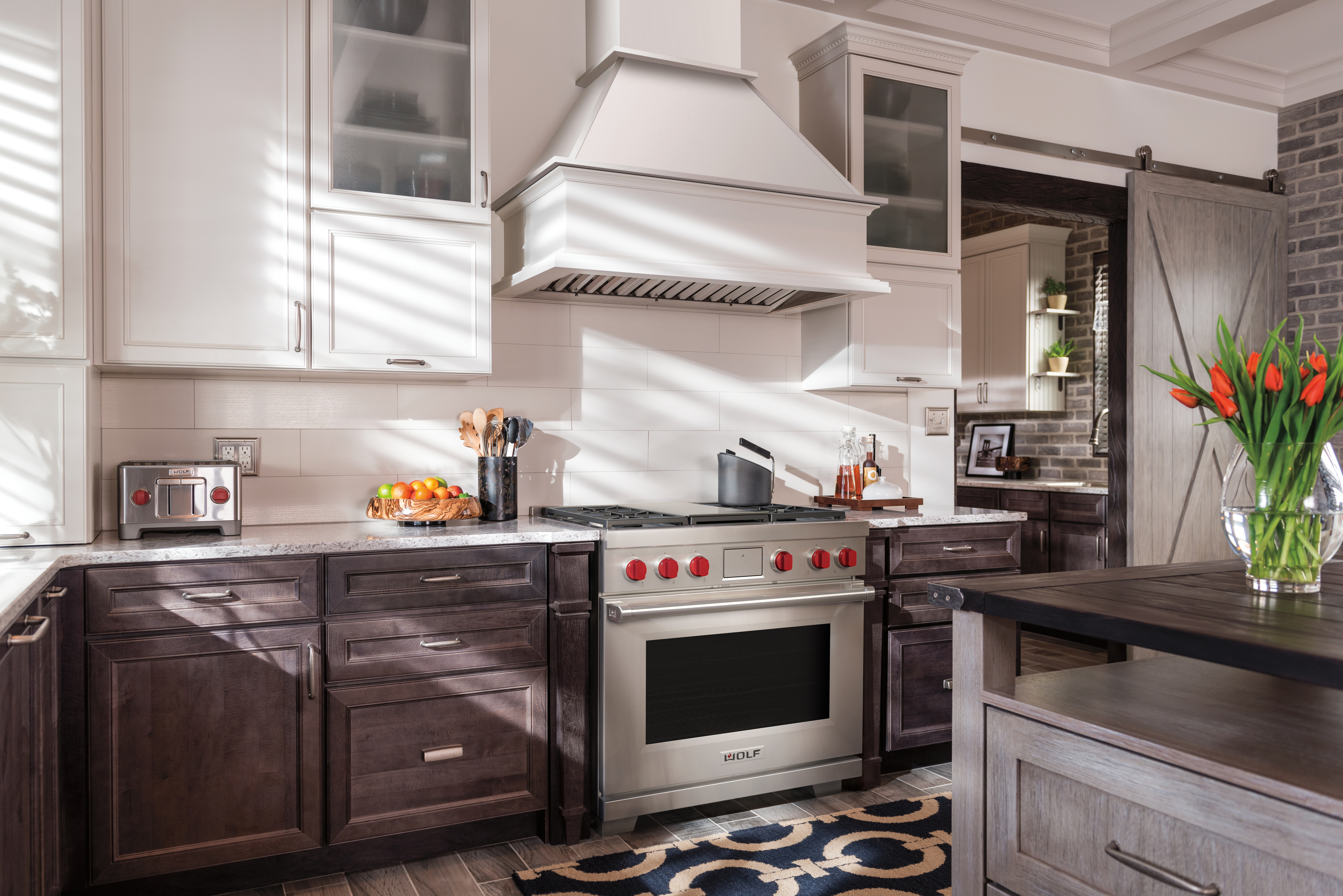 Wolf kitchen with range, rangehood, and toaster