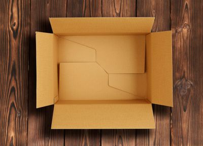 Overhead view of an open box on a wooden background 