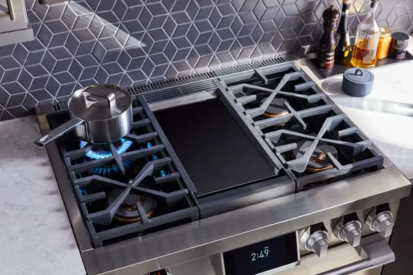 An overhead view of cooking on a SKS 36" gas range