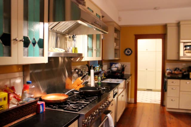 View of a modern kitchen with a gas range and powerful range hood View of a modern kitchen with a gas range and powerful range hood