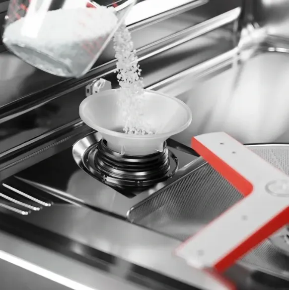 Credit: Bosch Benchmark A person pouring solvent into the Bosch Benchmark SHX9PCM5N water softener