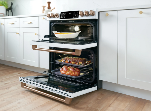 Credit: Cafe An open Cafe CES750P2MS1 double oven range with various items inside