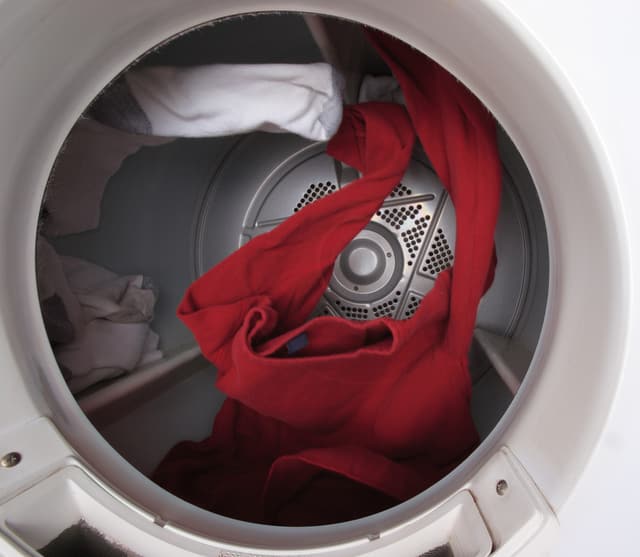 View of clothes tumbling in a dryer