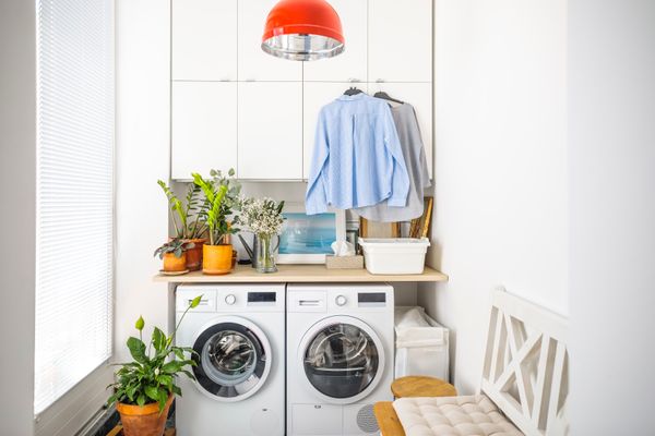 A laundry room with a front load washer and dryer and décor 