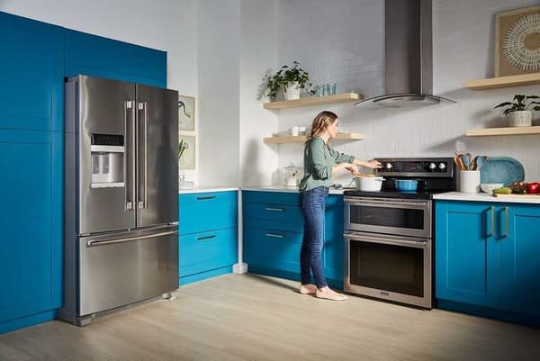 A woman cooking on a double oven range