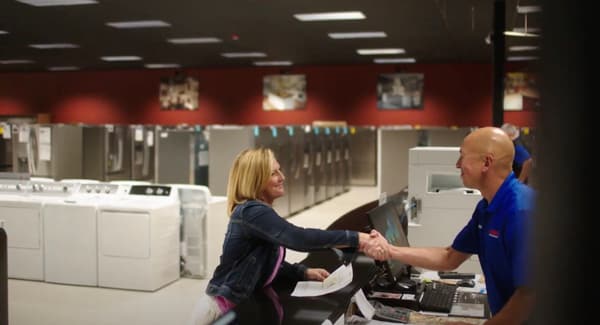 Fred’s Appliance expert discussing options with a customer