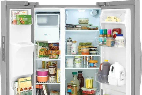 A close-up of groceries inside the Frigidaire FRSS2623AS refrigerator 