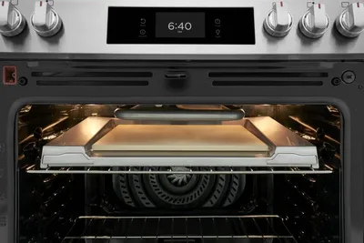 A close-up of the Frigidaire Stone-Baked Pizza stone in a range oven 