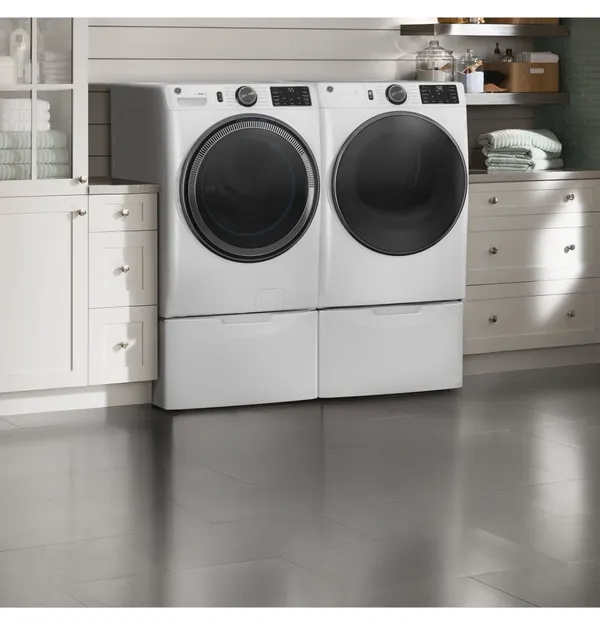 The GE GFD65ESSVWW dryer and matching washer in a laundry room