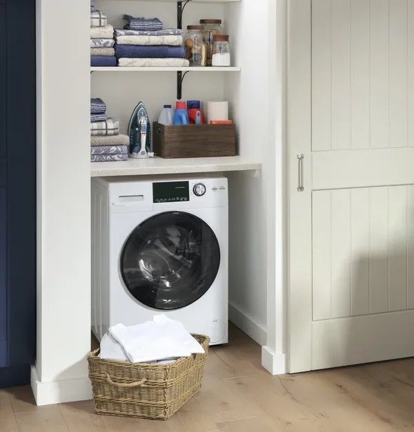 The GE GFQ14ESSNWW washer dryer combo in a closet