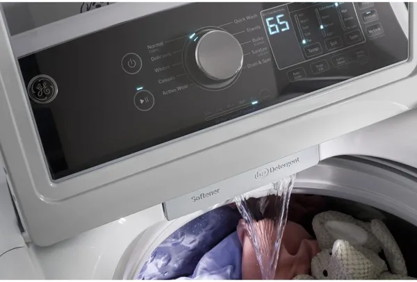 A close-up of the water spout on the GE GTW585BSVWS washer