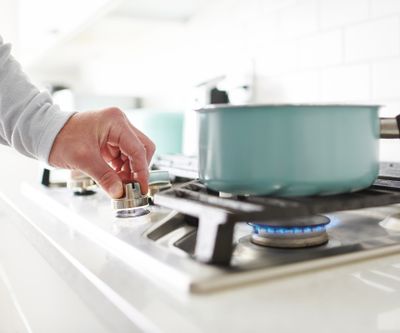 A person igniting a gas burner 