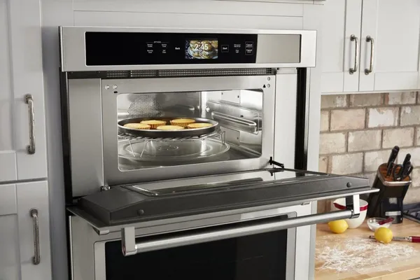 An open KitchenAid KOCE900HSS combo wall oven