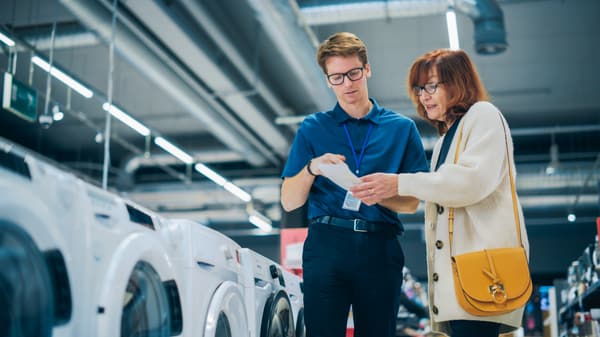 An appliance salesperson and a shopper in a discussion