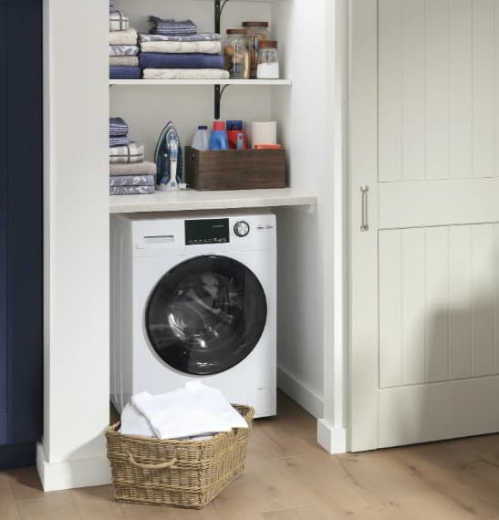 View of a GE washer dryer combo in a laundry closet