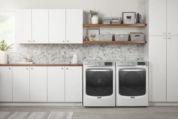 The Maytag MHW8630HW washer and dryer in a laundry room 