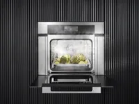An open Miele DGC 7780 CTS steam oven with artichokes inside