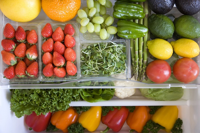 gyro Crisper drawer of fridge filled with fruits and vegetables.