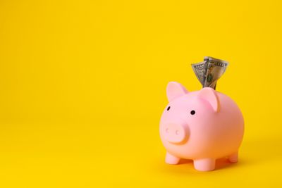 A piggie bank against a yellow background