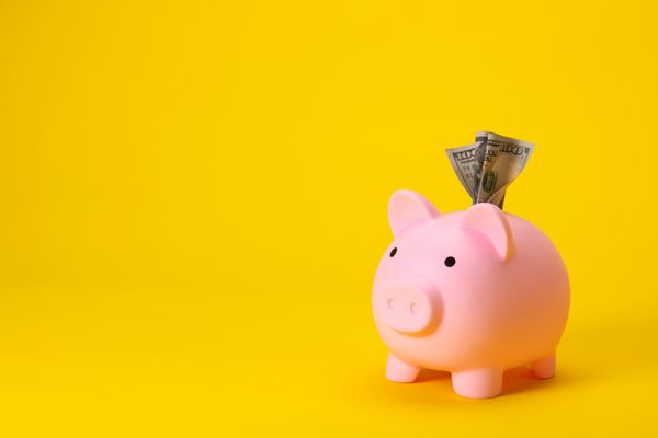 A piggie bank against a yellow background
