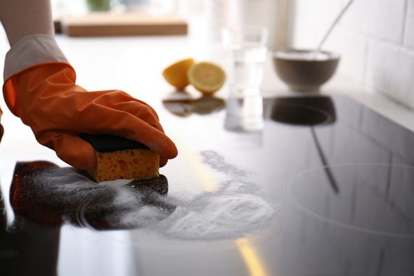 iStock Credit: Liudmila Chernetska Cleaning powder on a glass cooktop