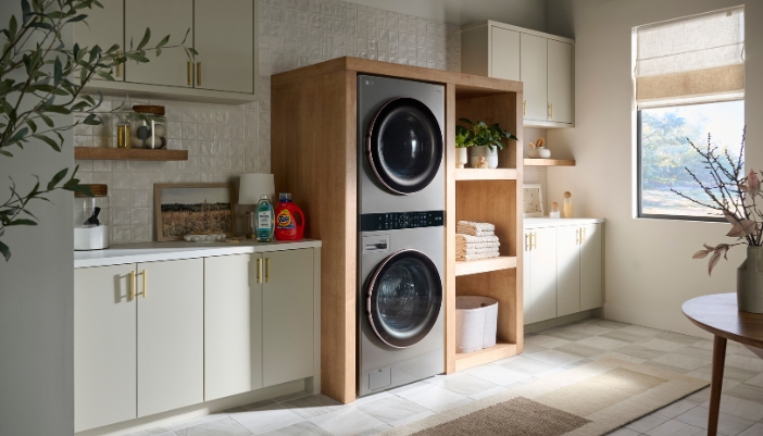 A laundry center in a well-lit modern laundry room with natural wood accents. 