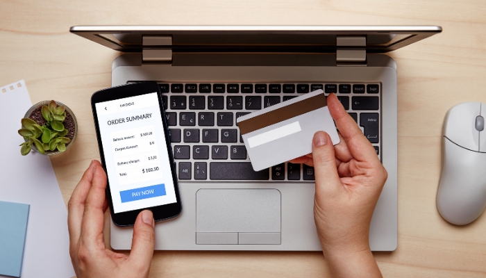 App_Appliance-Shopping-FAQs_1.jpg Closeup of someone paying for something online with a credit card; budget concept