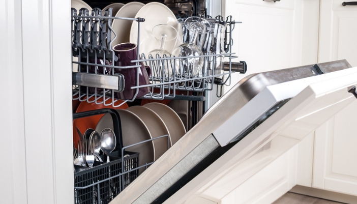 Close-up of a dishwasher interior filled with clean dishes.
