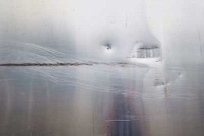 A close-up of a scratched, steel surface 
