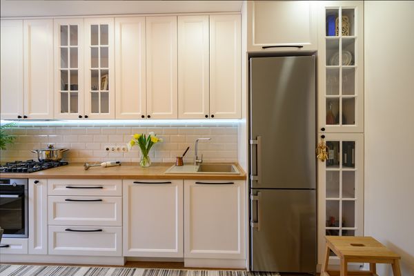 A 30” stainless steel refrigerator in a modern farmhouse kitchen