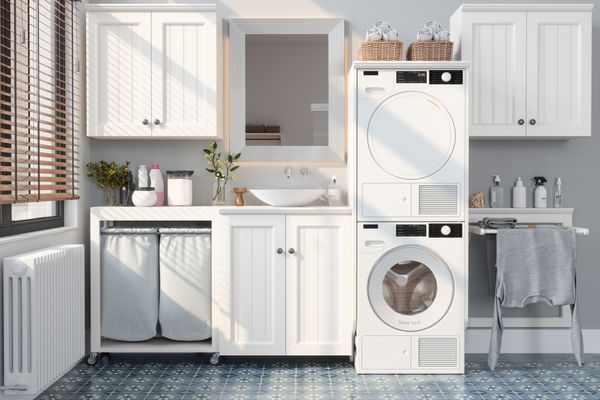 A stacked washer and dryer in a farmhouse laundry room