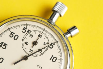 A stopwatch on a yellow background