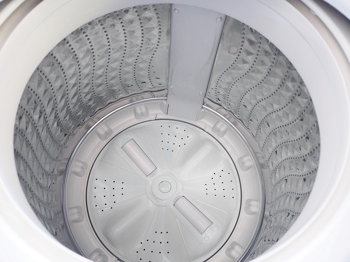 Top view of empty impeller washer with a shiny metal wash basket. 