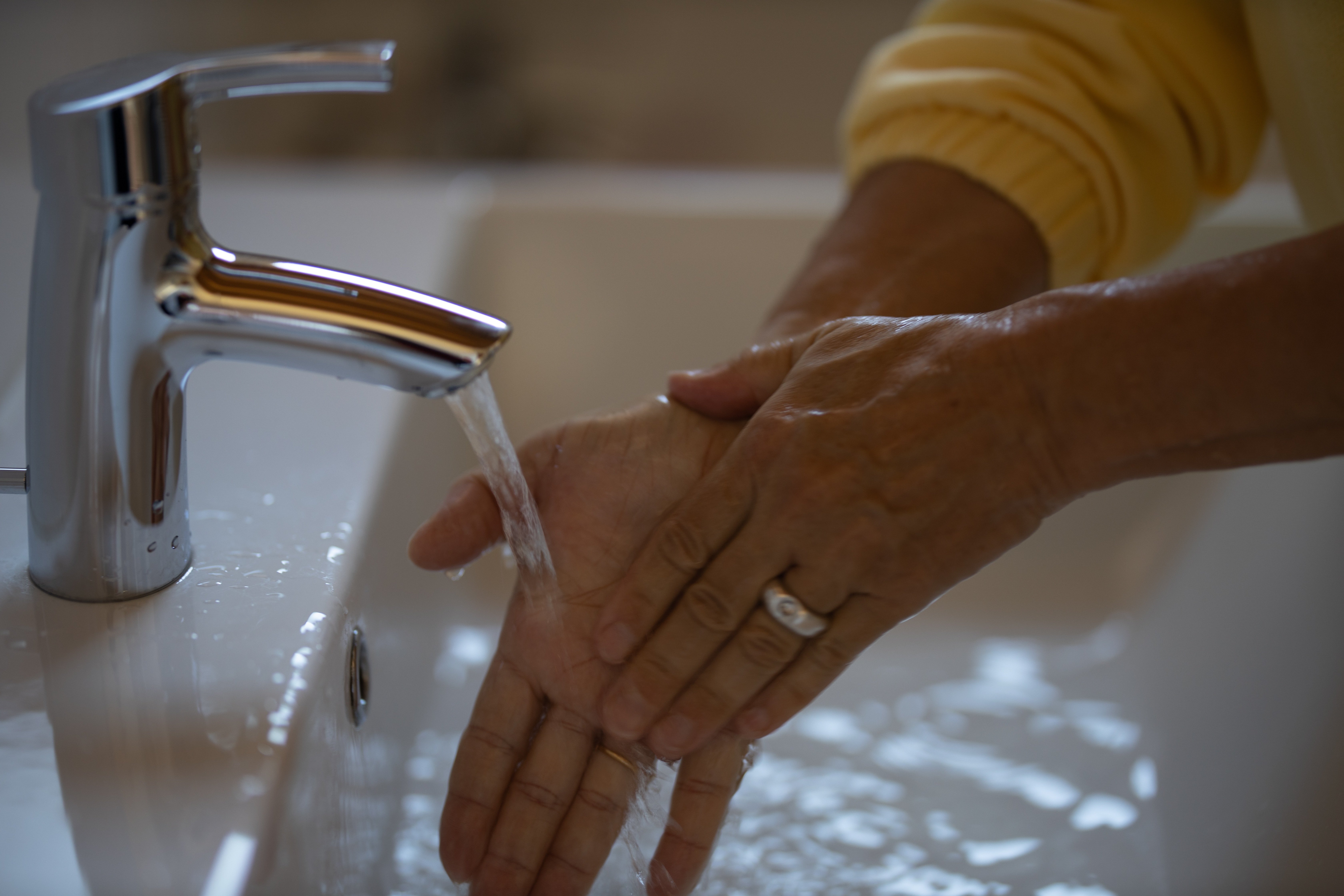 Using sink to wash hands Washing Hands in a Sink