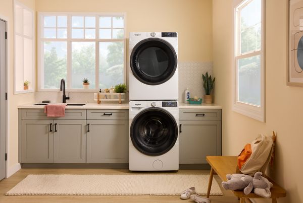 The Whirlpool WFW5720RW stacked washer and dryer in a laundry room 