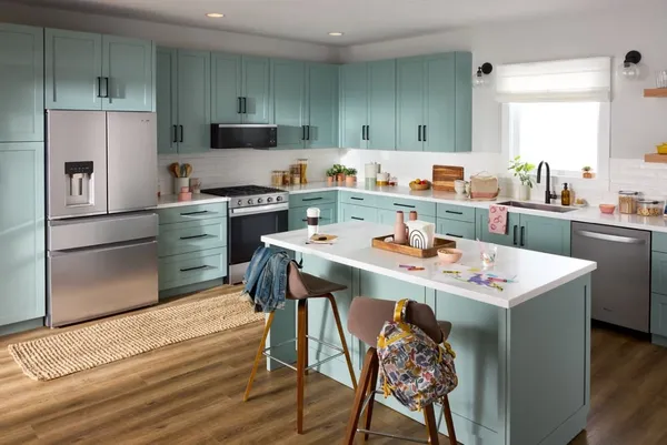 The Whirlpool WRMC5036RZ refrigerator in a blue-themed kitchen 