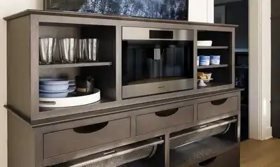 A Wolf built-in coffee maker in a cabinet