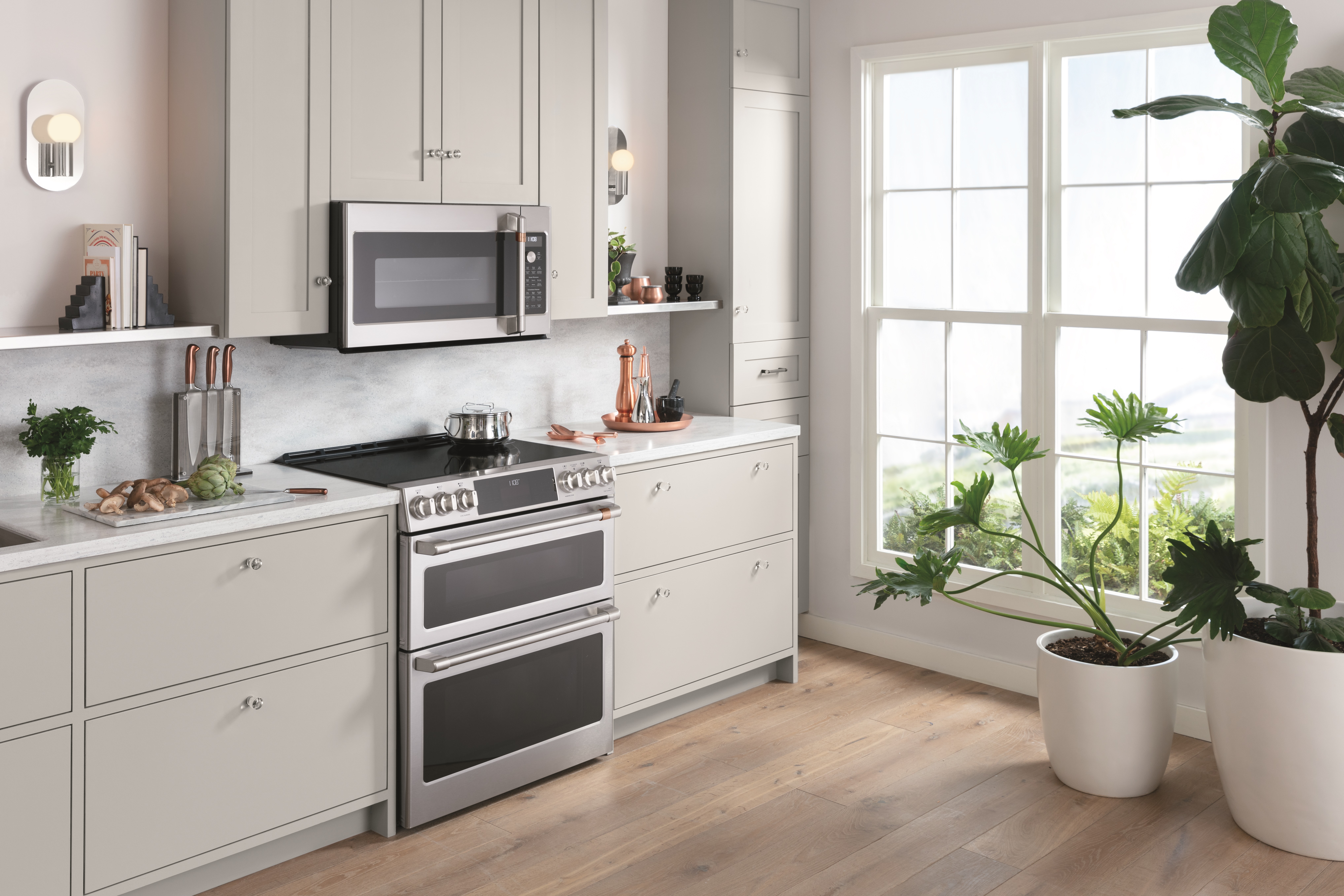 Wide shot of a kitchen featuring a Café double oven range 
