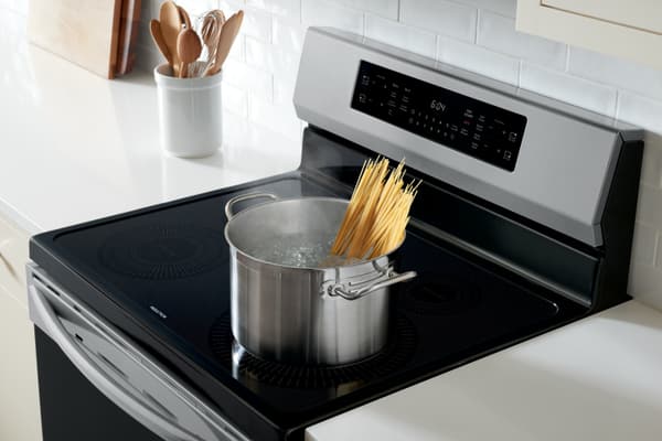 Induction Range A pot boils water for spaghetti atop a freestanding induction range
