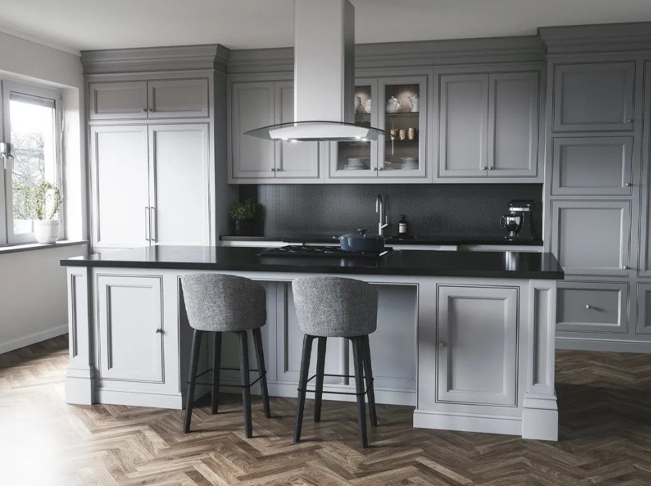 Zephyr A glass island range hood is featured above an island in an elegant kitchen