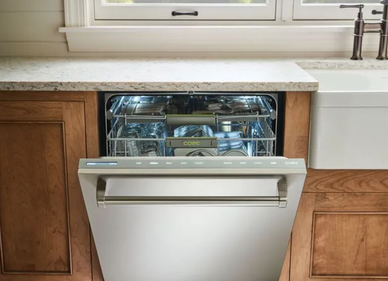 Close-up of clean dishes inside a built-in Cove dishwasher.