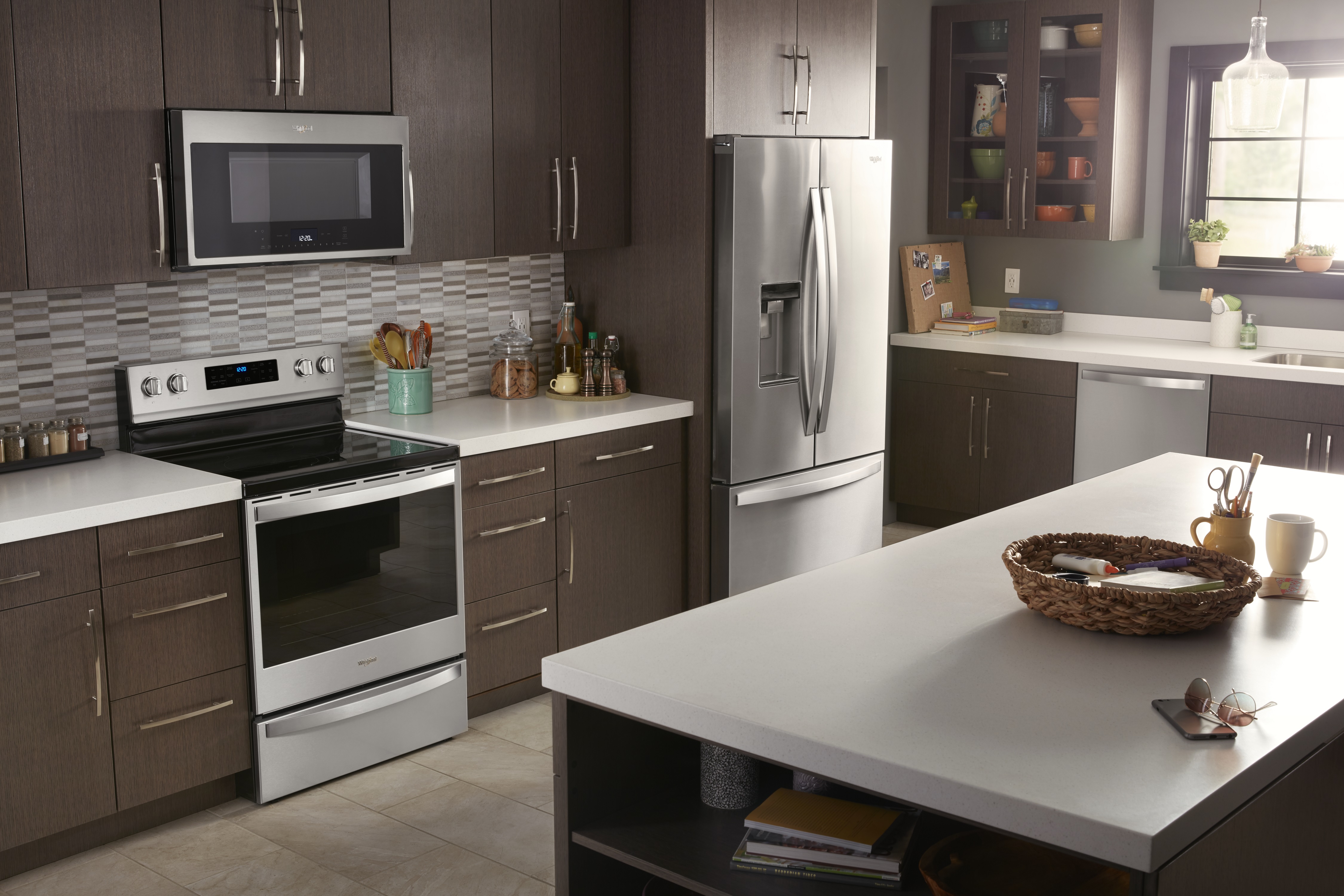 Whirlpool sunlit kitchen with stainless steel appliances including a Whirlpool freestanding electric range