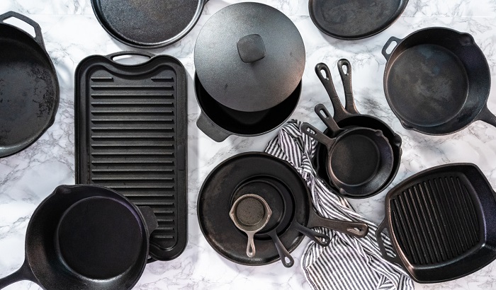 arinahabich Variety of cast iron frying pans on a marble background.