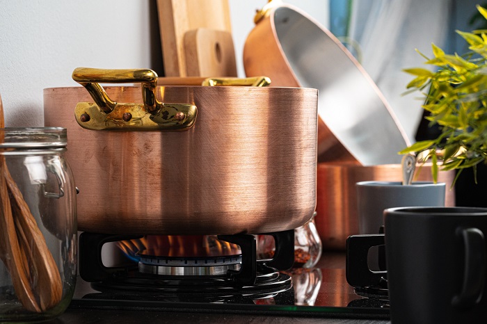 FabrikaCr Metal pot on a gas stove burner.