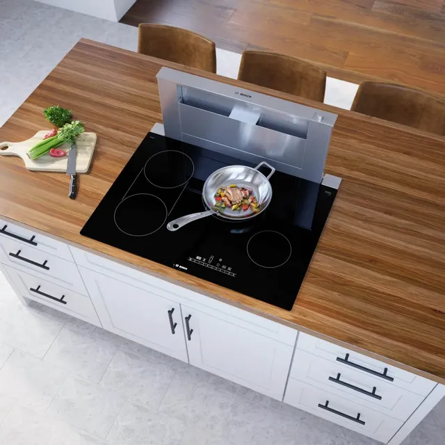 The Bosch 800 Series NET8069UC 30” electric cooktop preparing food 